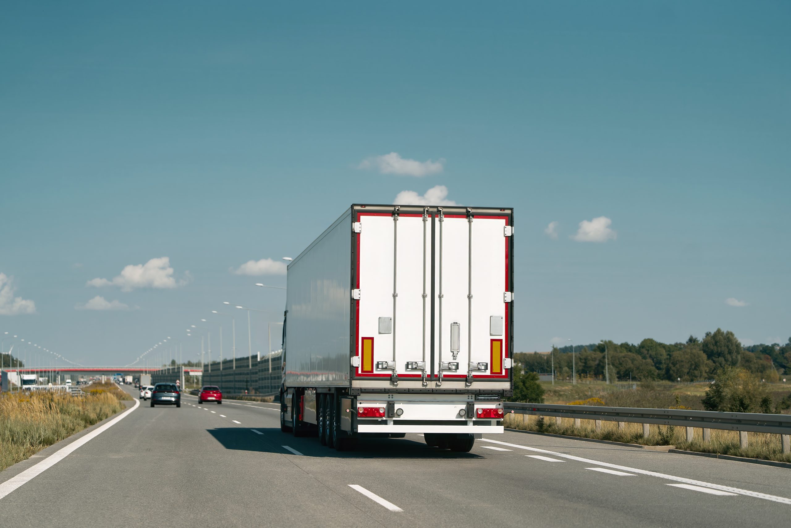 Rear view of truck driving on highway.